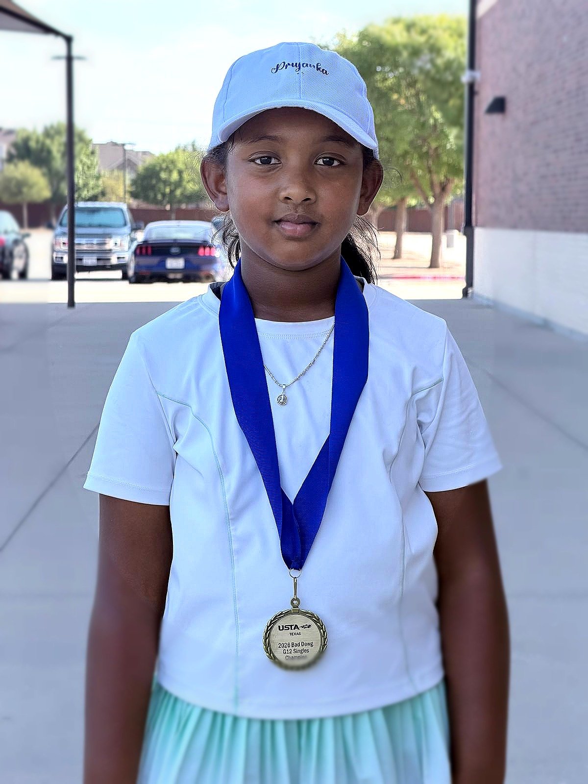 Priyanka wearing her Bad Dawg FRISCO championship gold medal